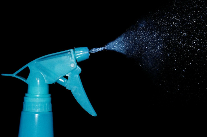 Black and blue image of a household cleaning spray