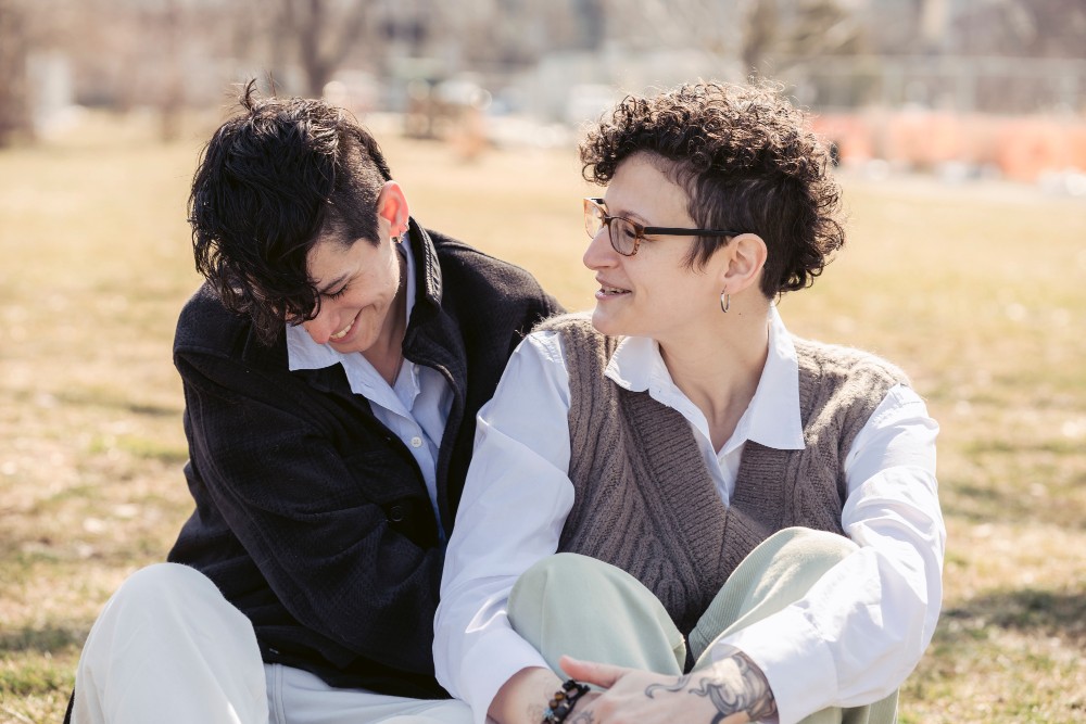 An LGBTQ couple laughing together 