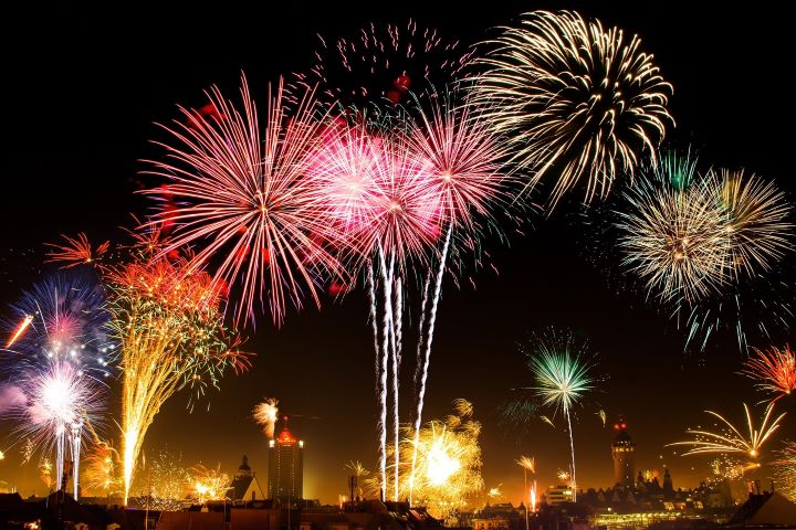 New Year's Eve fireworks over a city skyline.