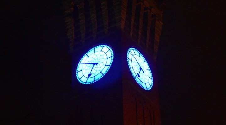 The Old Joe Clock Tower faces emit a blue light