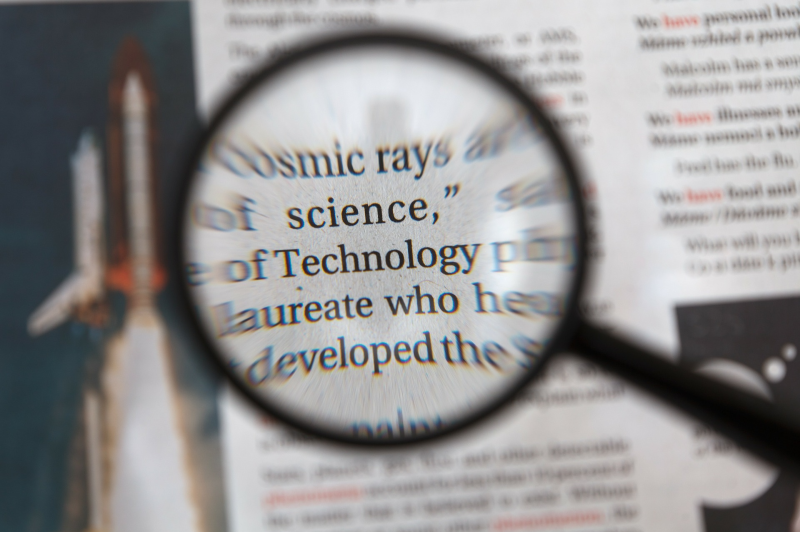 A magnifying glass over a scientific dictionary