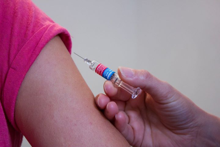 Vaccine being administered by syringe