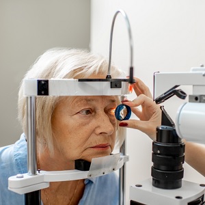 Older woman having an eye examination with optician