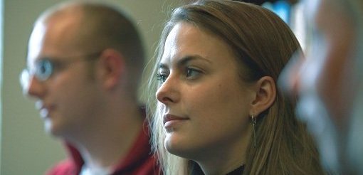 Female seminar attendee listening to seminar