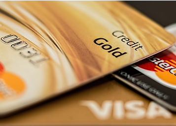 Gold credit card on pile of credit cards