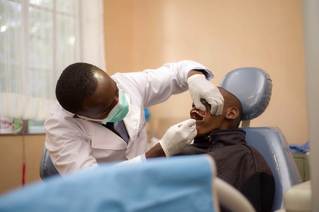 A Kenyan doctor examines a patient's mouth