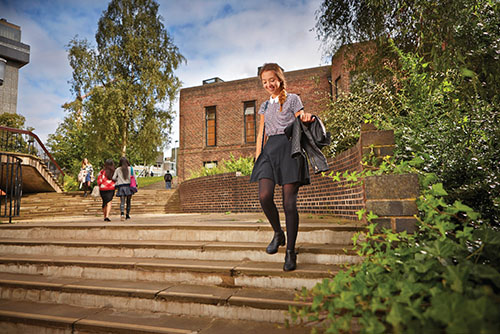 Student descending steps on campus