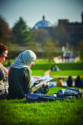 Student studying on the campus green heart