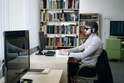 A visual impaired student working in a study