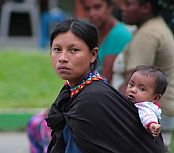 South-American native woman carrying a child on her back