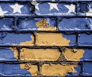 Kosovo flag painted on a brick wall