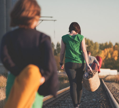 Refugees walking along railroad tracks