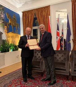 Ambassador of Albania to the UK, his Excellency Qirjako Qirko, handing over the Albanian Nation’s Ambassador Award to Dr Gëzim Alpion