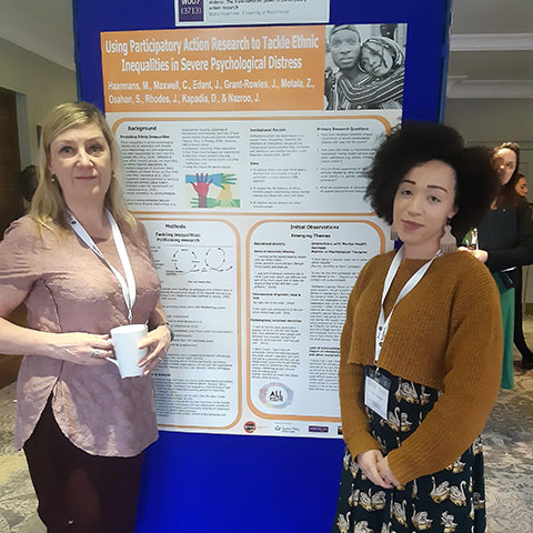 Dr Maria Haarmans with Charlotte Maxwell in front of their PAR project poster
