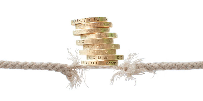 A pile of coins on top of a frayed rope