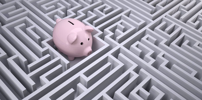 A plastic piggy bank in the middle of a model maze