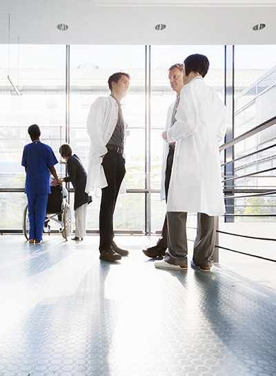 Doctors meeting in hospital corridor