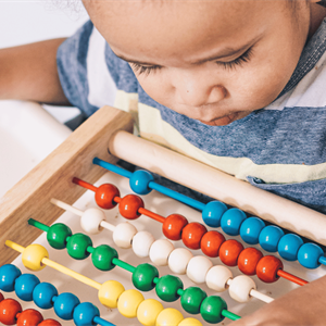 child looking at abacus