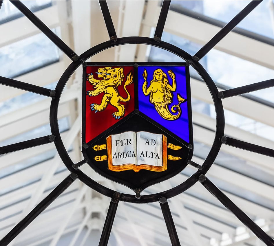 A stained glass window in The Exchange featuring the University of Birmingham's crest