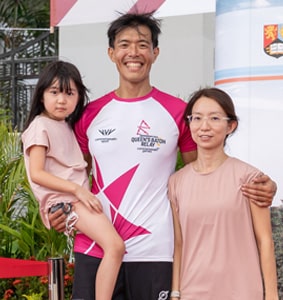 Singapore batonbearer Alvin Ho standing with his daughter and wife