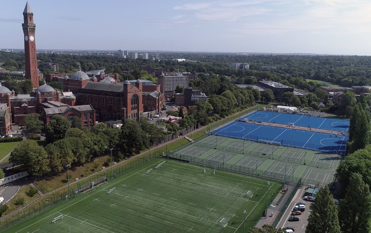 Aerial view of the University of Birmingham's Metchley Lane synthetic pitches with 'Old Joe' and the Aston Webb building visible.