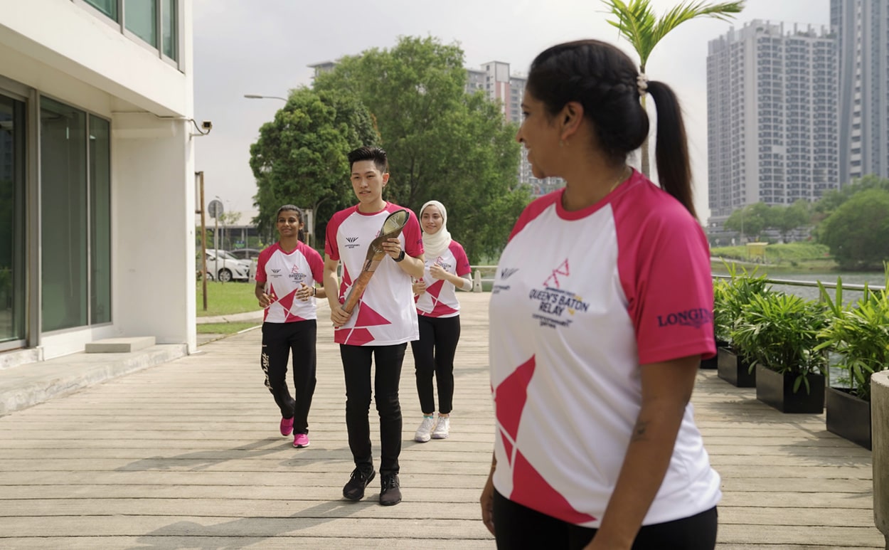 Four Malaysian Batonbearers from Taylor’s University running with the Queen's baton