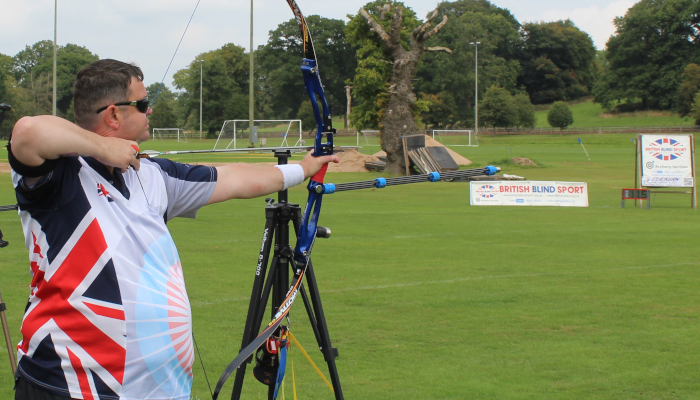 British Blind Sport Archer Clive Jones taking aim at a target