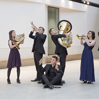 Young musicians posing with instruments at jaunty angles