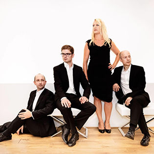 Tippett Quartet posing in front of white background