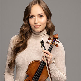Geneva Lewis holds a violin staring at the camera