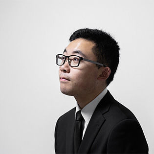 Rob Hao looks to the left against a white background