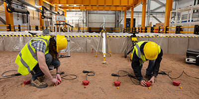 Researchers placing sensors on the ground to gather below ground measurements