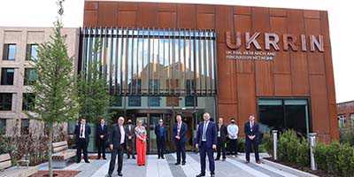 University senior managers standing outside of the UKRRIN building
