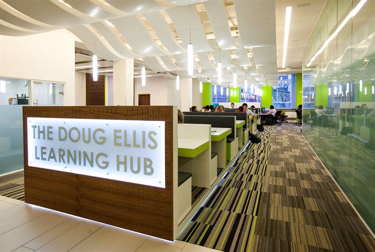 The Doug Ellis Learning Hub with tables and students studying