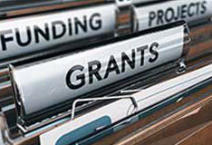filing cabinet with header tabs of funding projects and grants