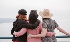 three-women-hugging-looking-out-to-sea