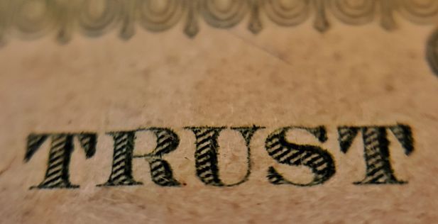 The word trust on a banner