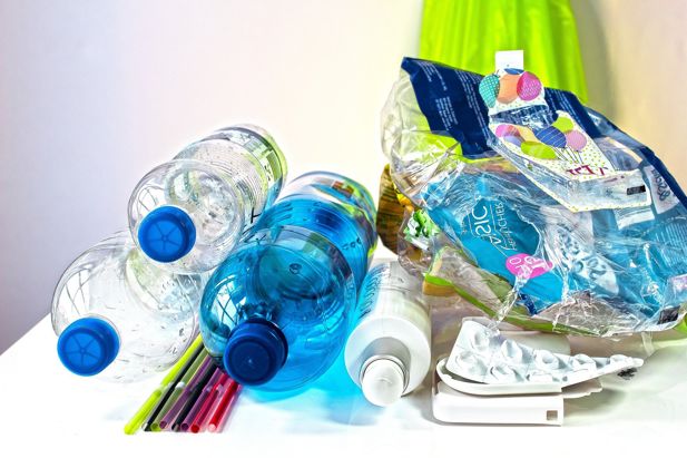 A small pile of plastic waste, including bottles, straws and wrapping.