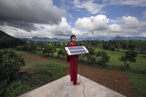 Indian woman holding a solar panel