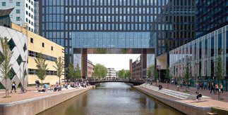 Modern buildings on the University of Amsterdam's campus with a canal running through the middle.