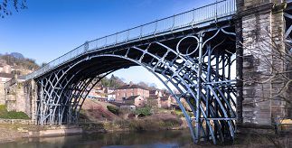 The Iron Bridge arching across the River Severn in Shropshire, England, on a lovely sunny day.
