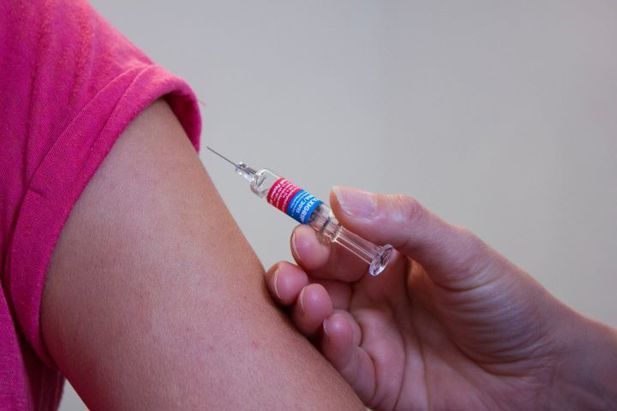 Image of someone being given a vaccine.