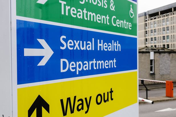 Hospital sign directing visitors to the Sexual Health Clinic