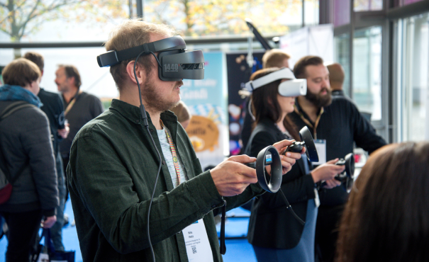 A man using Virtual Reality at a convention.