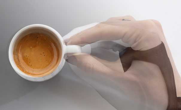 Robotic and human hand superimposed grasping a coffee cup