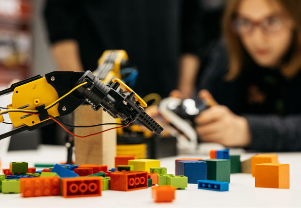 Photograph of a computer arm with lego bricks