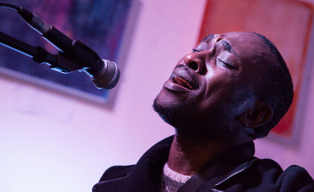 Photograph of Didier Kisala performing with a microphone