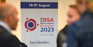 A photo on a banner stand with the text 18 - 27 August IBSA World Games Birmingham 2023. Blurred figures at the forefront.