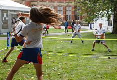 Students playing tennis on campus