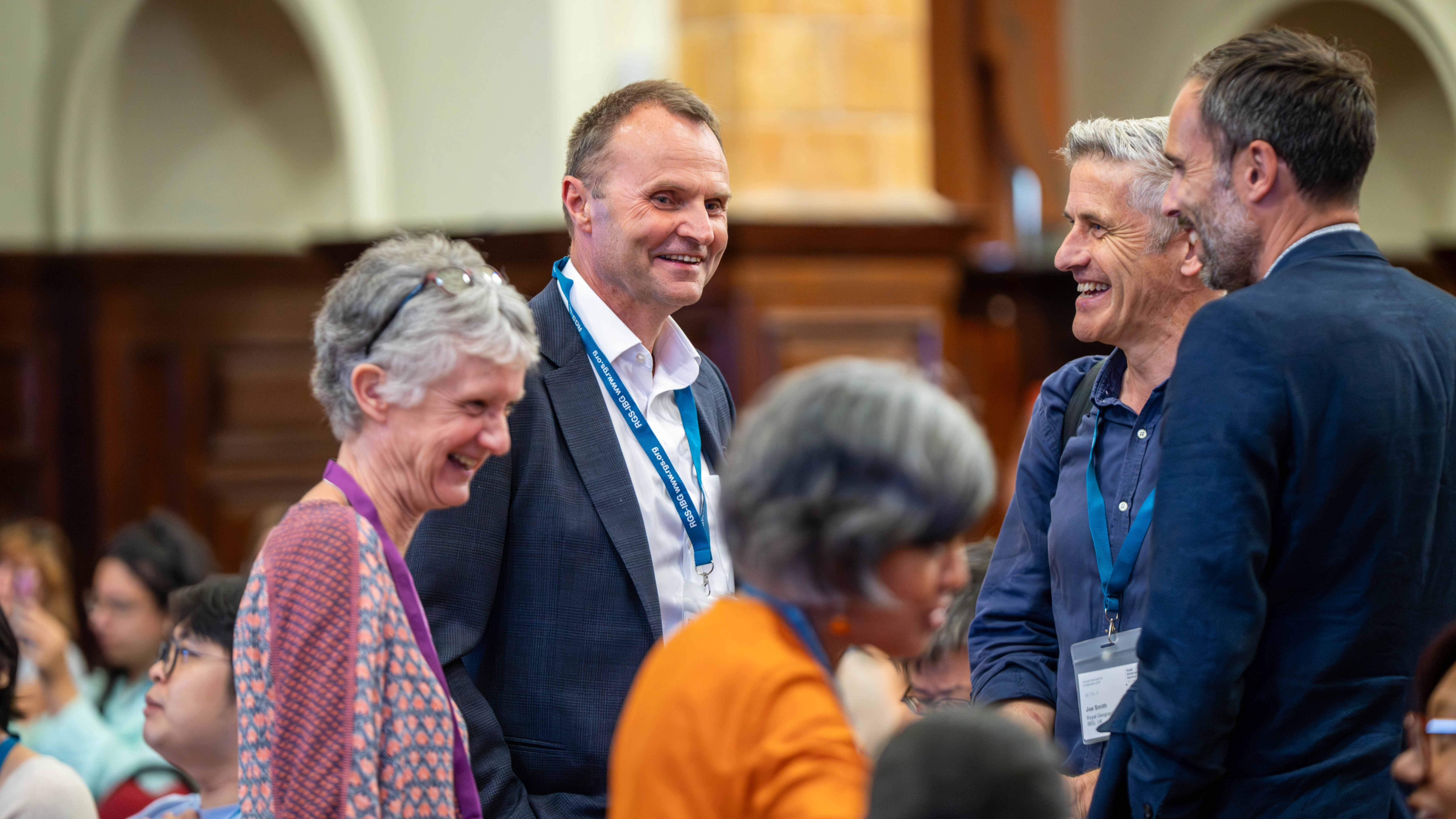 Delegates in the Great Hall talking and laughing